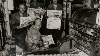 1996 Canberra Times printing press with workers holding copies of the newspaper