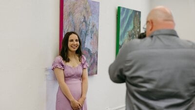 Student in front of their work at the graduating exhibition