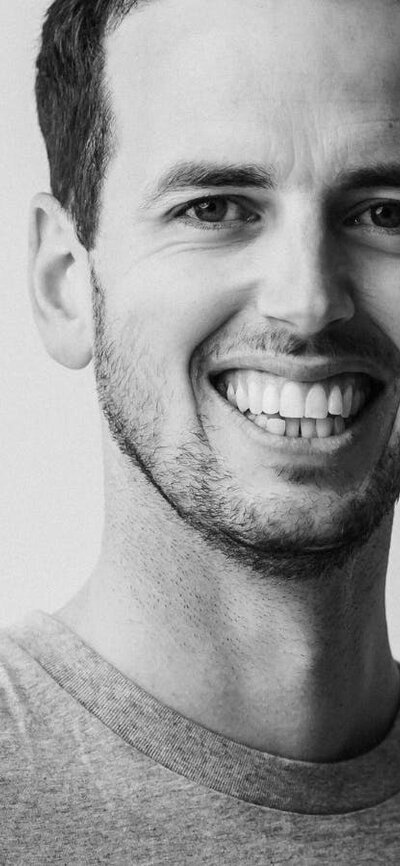 Wed 10 September: Chris Haddad RAIA and Josh FitzGerald RAIA, Archier (Hobart, Melbourne) Black and white image of portrait of man smiling and looking at camera