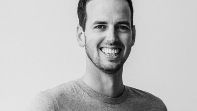 Black and white image of portrait of man smiling and looking at camera
