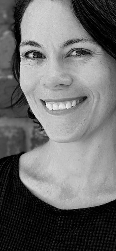 Wed 17 September: Suzannah Waldron RAIA, Searle x Waldron Architecture (Melbourne) Black and white profile image of woman smiling and looking at camera, hair is up