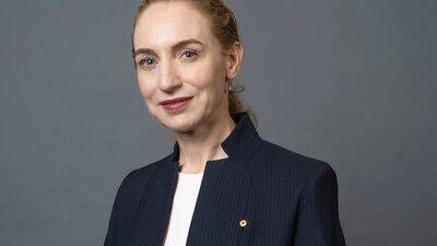 Headshot of a woman wearing a white shirt and blazer