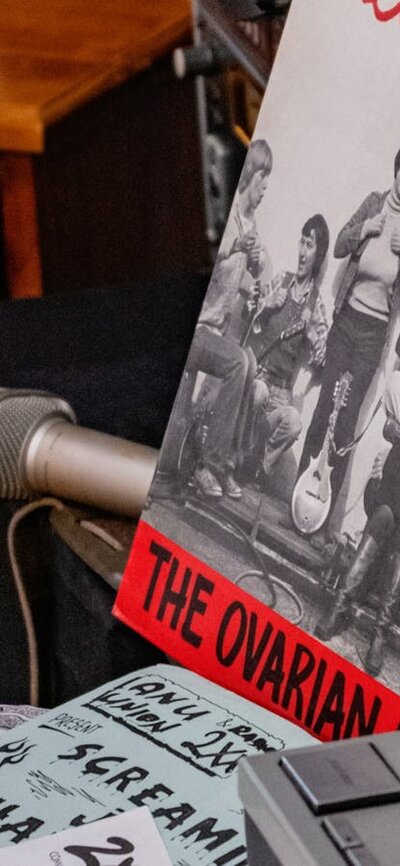 A mock studio desk with record reading 'Beat Your Breasts' in the 2XX exhibition at CMAG