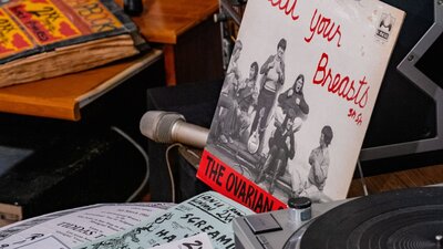A mock studio desk with record reading 'Beat Your Breasts' in the 2XX exhibition at CMAG