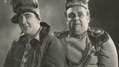 Black and white photo of two men dressed as kings