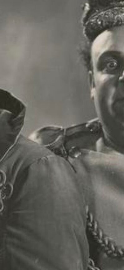 Black and white photo of two men dressed as kings