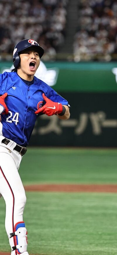 Baseball player from Taiwan National Team cheering as he runs across the field