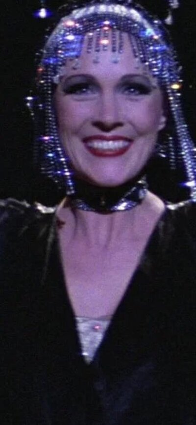 Woman performing with two men on either side wearing white hats