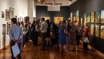 A Total Work of Art: Sidney Nolan and the Stage A group of people exploring the exhibition A Total Work of Art: Sidney Nolan and the Stage