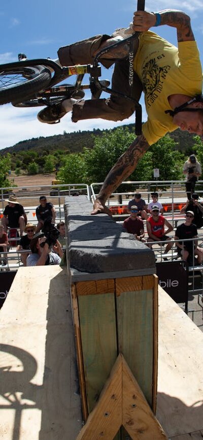 Jonny Mackellar doing a 360 handplant over a hitching post wall at ACT JAM 2023 Jon Mackellar riding BMX doing a handplant over a hitching post wall at ACT JAM 2023