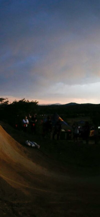Jason Watts riding a big dirt jump doing a 360 at sunset at Stromlo Forest Park