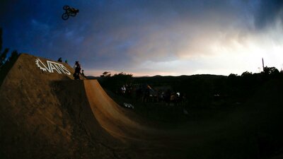 Jason Watts riding a big dirt jump doing a 360 at sunset at Stromlo Forest Park