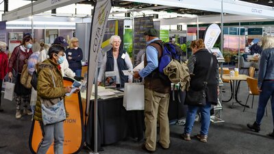 People standing at COTA ACT Expo stall