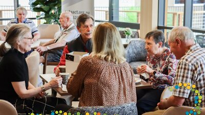 Seniors sitting around a table talking