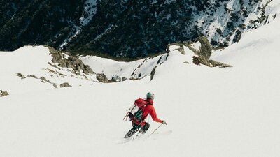 Wide snow mountain photo with man skiing downhill