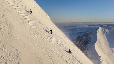 Wide shot of climbers up a snowy mountain