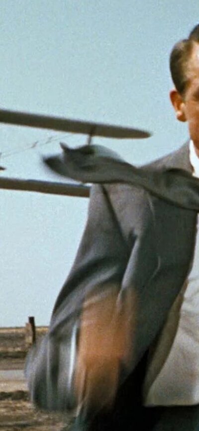 North by Northwest (1948) Man in suit and tie running from an airplane