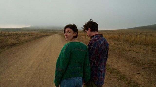 Alphabet Lane + Q&A, 20 June, 2026 Young woman and man pictured in a flat field, woman looks back at camera