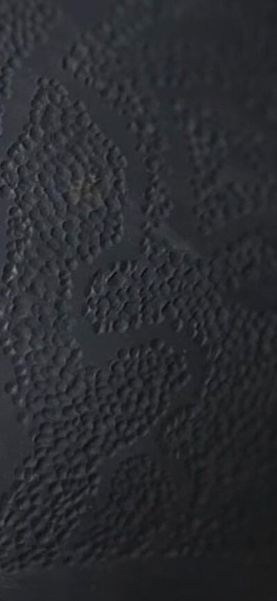 Dark round ceramic urn with dot texture
