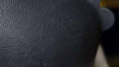 Dark round ceramic urn with dot texture