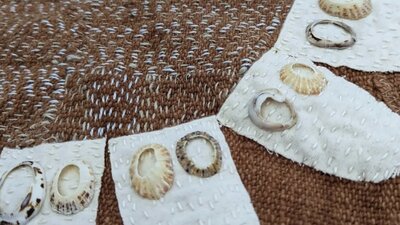 brown textile with white fabric petals and shells