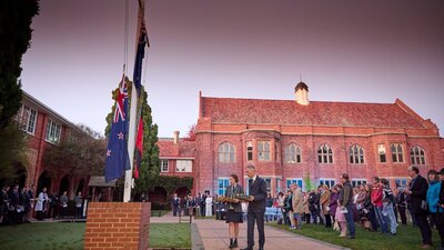 Head of School lays a wreath with a student at the Grammar School dawn service
