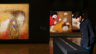 Installation view, Arthur Boyd: Tapestries, National Gallery of Australia, Kamberri/Canberra, 2026 View of inside art exhibition with large tapestry and a visitor