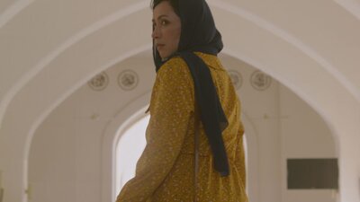 Maryam (Maryam Pagi Ke Malam) Woman looks back at camera, wears a head scarf