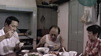 Three people eating at a table