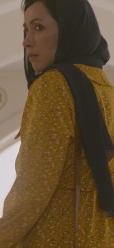 Maryam (Maryam Pagi Ke Malam) Woman looks back at camera, wears a head scarf