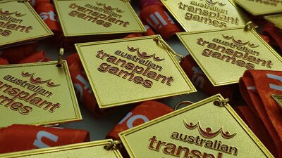 a collection of gold medals engraved with australian transplant games