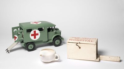Objects including gas mask, replica ambulance, tea pot and medical