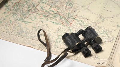 Binoculars and map