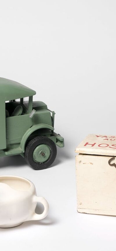 Objects including gas mask, replica ambulance, tea pot and medical