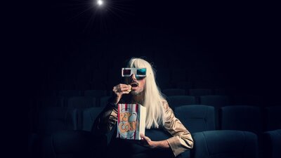 Venus Mantrap pictured in a cinema eating popcorn