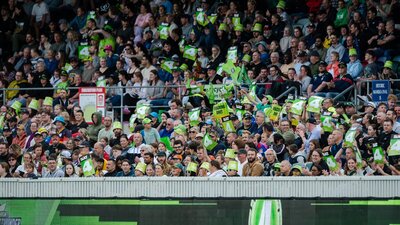 The crowd celebrates a Thunder boundary at Manuka Oval