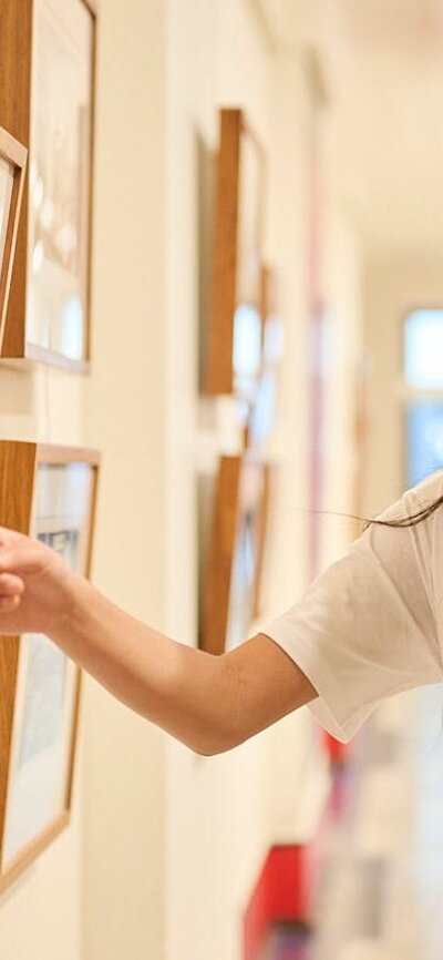 Children view artwork in gallery.