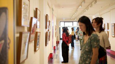 People view artwork in gallery.
