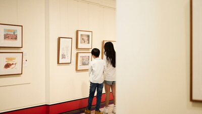 Children view artwork in gallery.