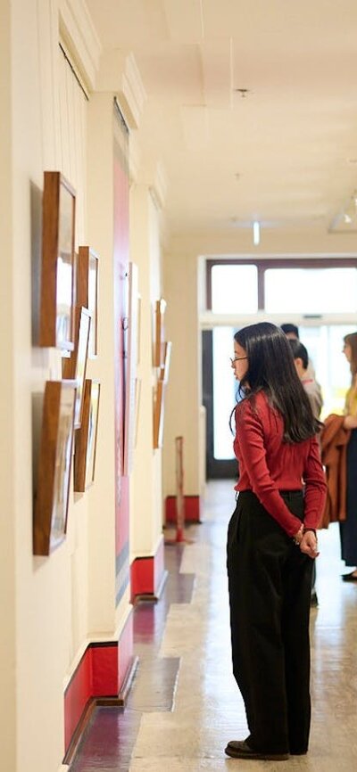 People view artwork in gallery.