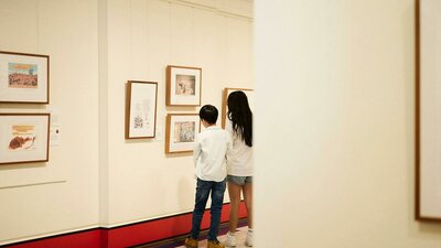 Children view artwork in gallery.