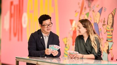 Man with glasses and lady playing cards at a table