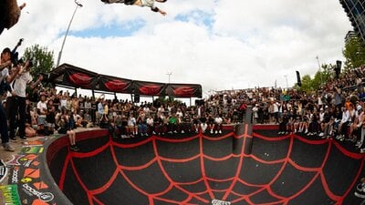 Skateboarder peforming backside air in Belconnen Bowl