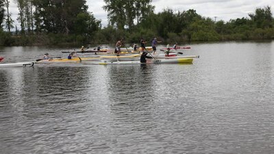 a row of paddlers lining up at the start line