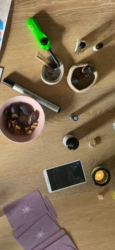 Overhead view of breathwork space with seasonal flowers, creative materials, journals, natural items