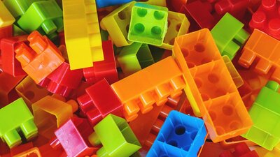 A pile of rainbow coloured building blocks