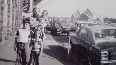 A sepia photograph of a father and his children.