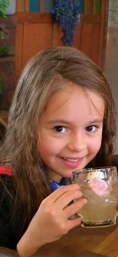 Q Brew Young witch drinking a QBrew