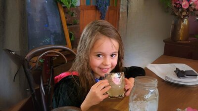 Q Brew Young witch drinking a QBrew