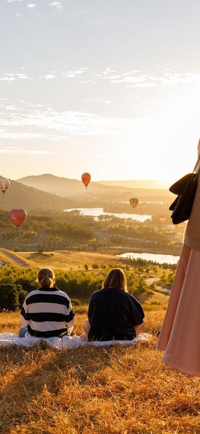 People up at lookout location to watch the balloons float over the Canberra skyline